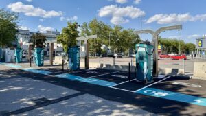 Mehrere moderne Schnellladepunkte von Electra am Standort Wien, mit blau markierten Stellplätzen und Ladegeräten bis 300 kW Leistung.